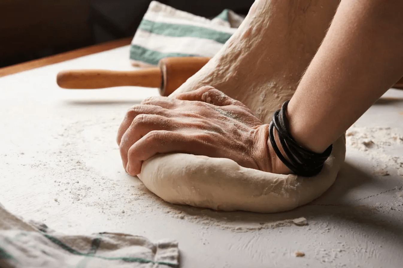 Person making pizza